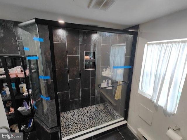 bathroom featuring tile patterned floors and a shower with shower door