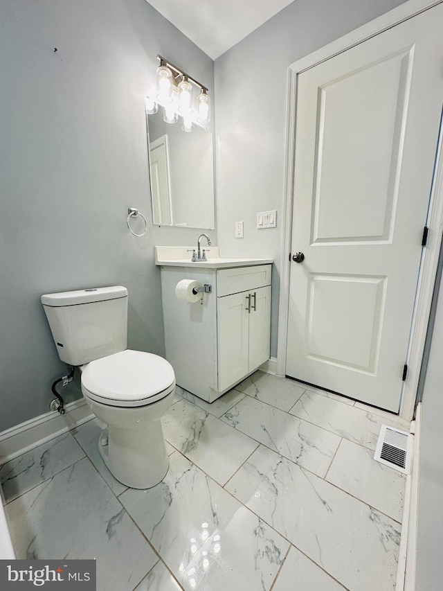 bathroom featuring vanity and toilet