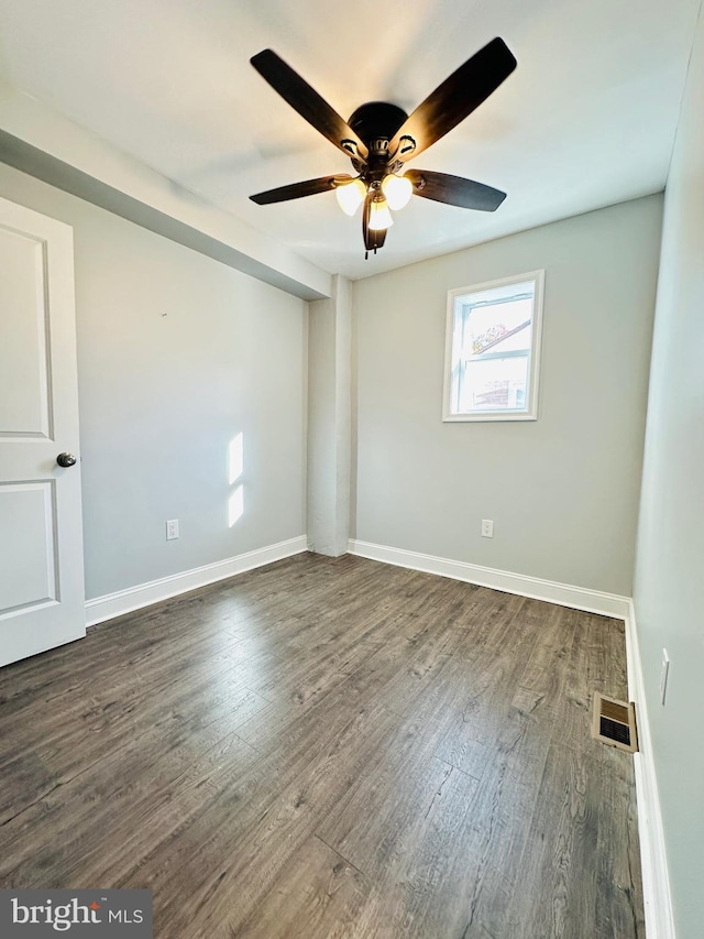 spare room with ceiling fan and dark hardwood / wood-style flooring