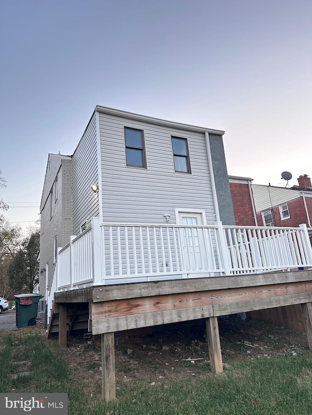 rear view of house featuring a deck