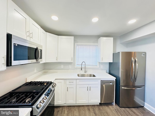 kitchen featuring sink, white cabinets, and appliances with stainless steel finishes