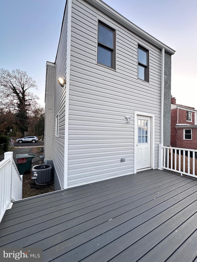 wooden deck featuring central AC unit