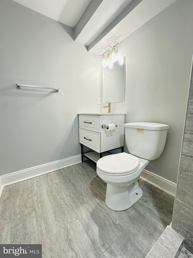 bathroom featuring vanity, hardwood / wood-style flooring, and toilet