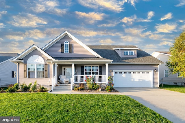 view of front of property with a front lawn, a porch, and a garage