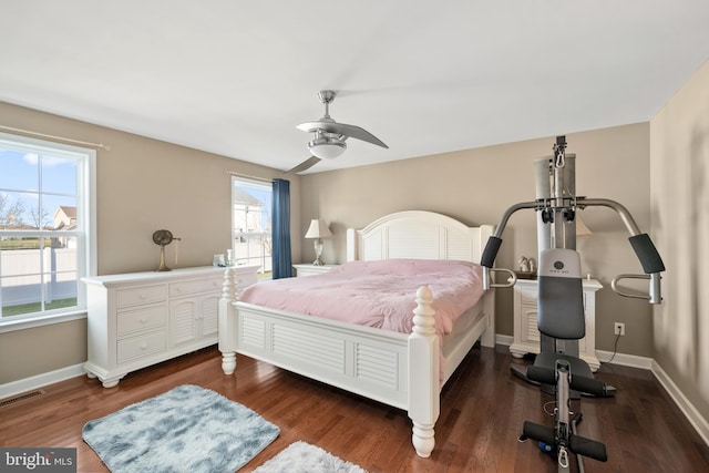 bedroom with multiple windows, ceiling fan, and dark hardwood / wood-style floors