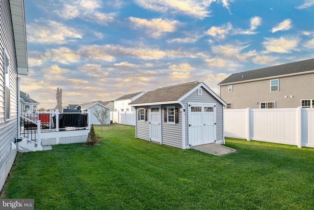 yard at dusk with a shed and a wooden deck