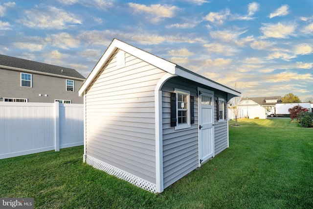 view of outbuilding featuring a yard