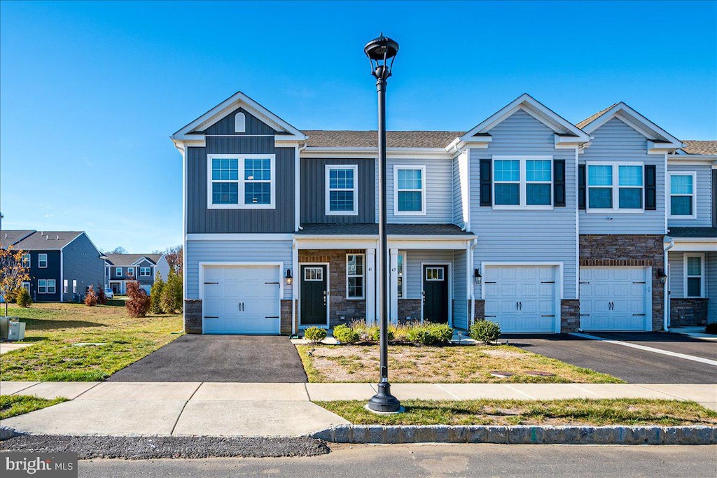 multi unit property featuring a garage