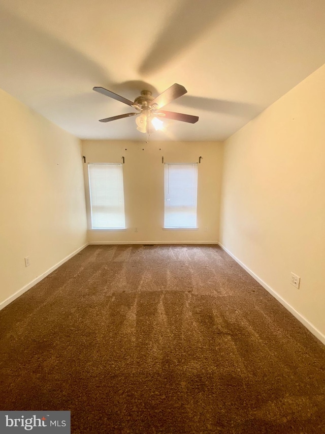 carpeted empty room featuring ceiling fan and a healthy amount of sunlight