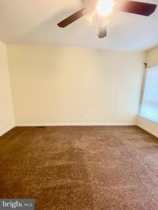 unfurnished room featuring ceiling fan and carpet floors