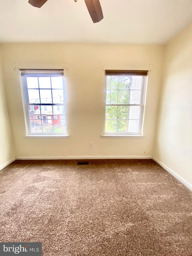 carpeted empty room featuring ceiling fan