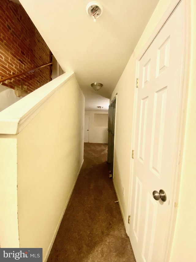 corridor with dark colored carpet