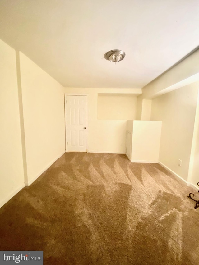 unfurnished room featuring carpet flooring