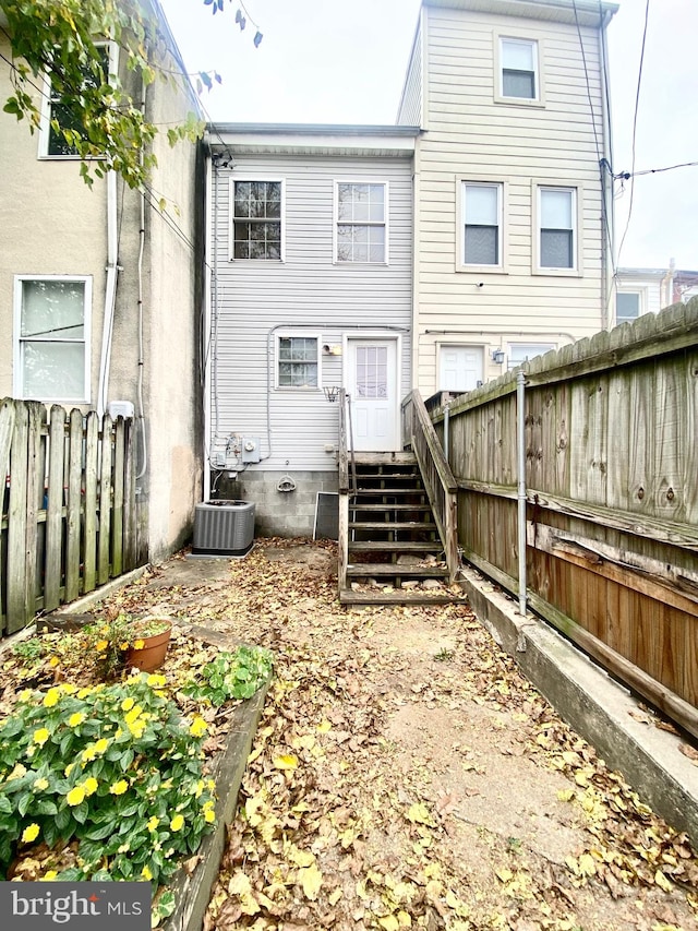 rear view of property with central AC unit