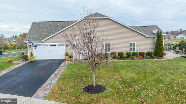 view of property exterior featuring a lawn and a garage