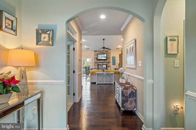 hallway with dark hardwood / wood-style floors and ornamental molding