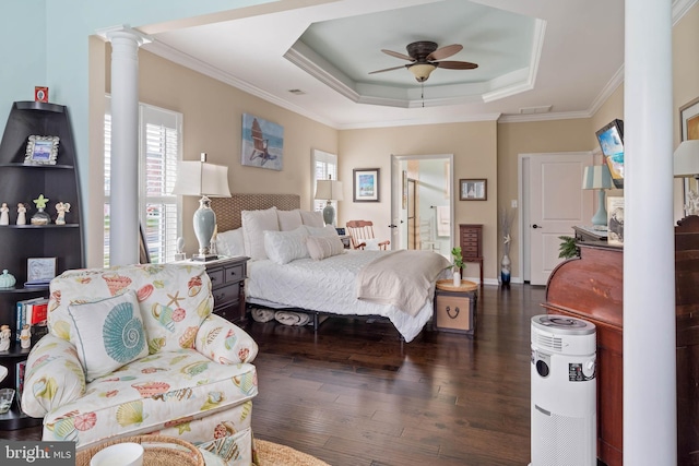 bedroom with a raised ceiling, ceiling fan, dark wood-type flooring, and ornamental molding