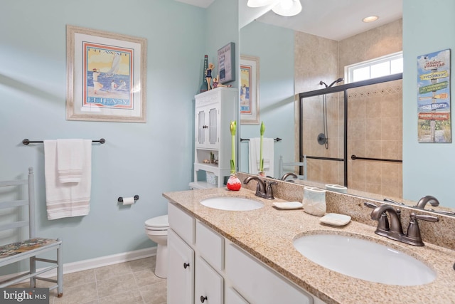 bathroom with tile patterned flooring, vanity, toilet, and a shower with shower door