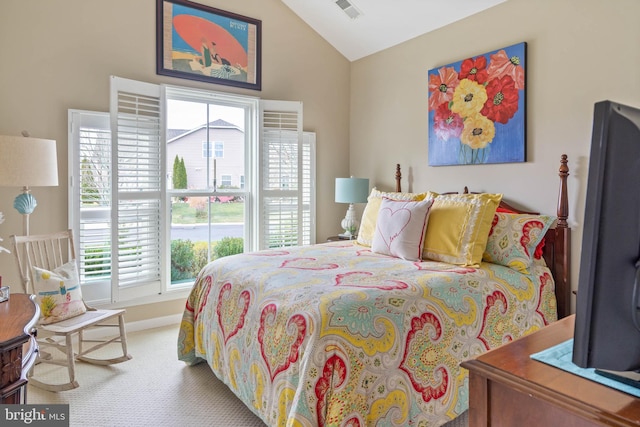 carpeted bedroom with vaulted ceiling and multiple windows