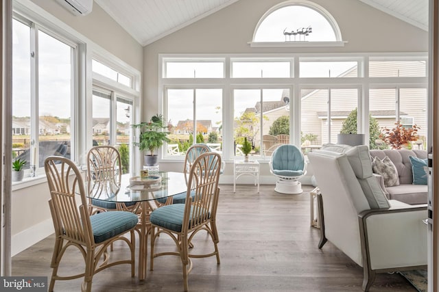 sunroom / solarium featuring a wall mounted AC and lofted ceiling