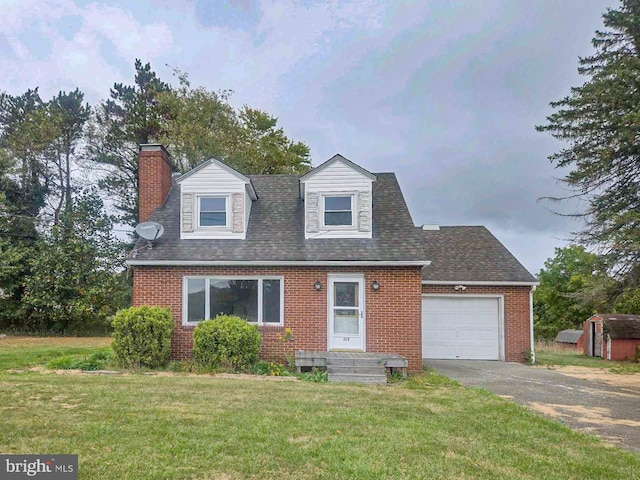 new england style home featuring a front yard, a shed, and a garage