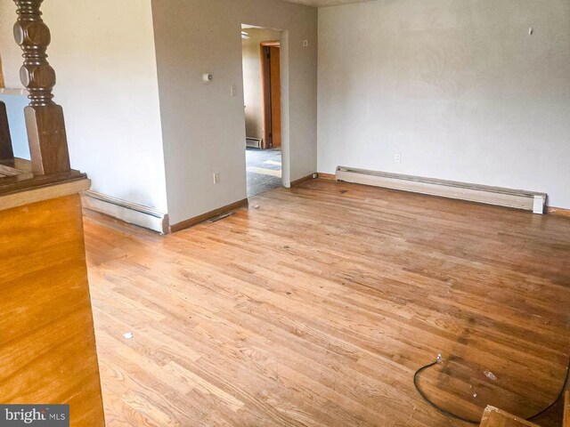 115 Mountain View Rd, Armagh, PA 15920 - spare room featuring a baseboard heating unit, baseboard heating, wood finished floors, and baseboards