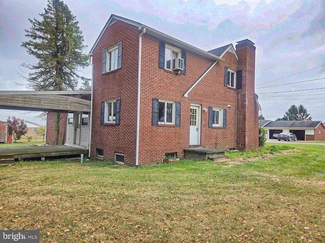 view of front of property with a front lawn and cooling unit