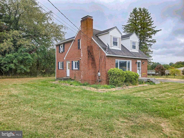 view of side of home with a yard