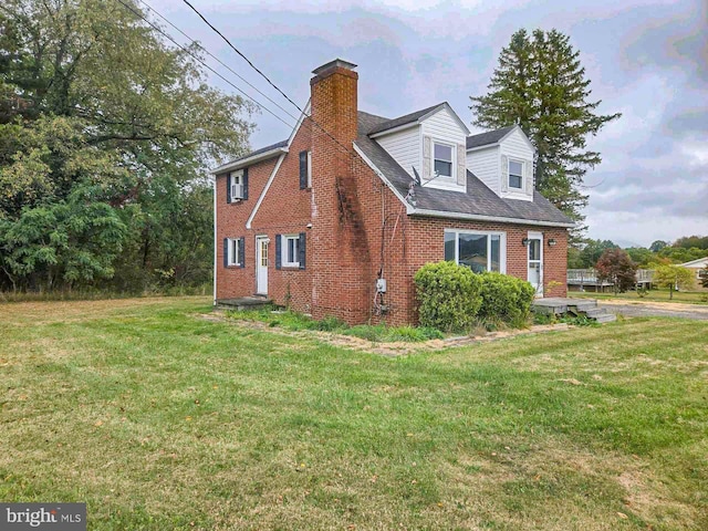 115 Mountain View Rd, Armagh, PA 15920 - view of side of home with brick siding, a chimney, and a yard