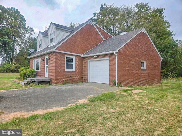 view of side of home featuring a yard and a garage