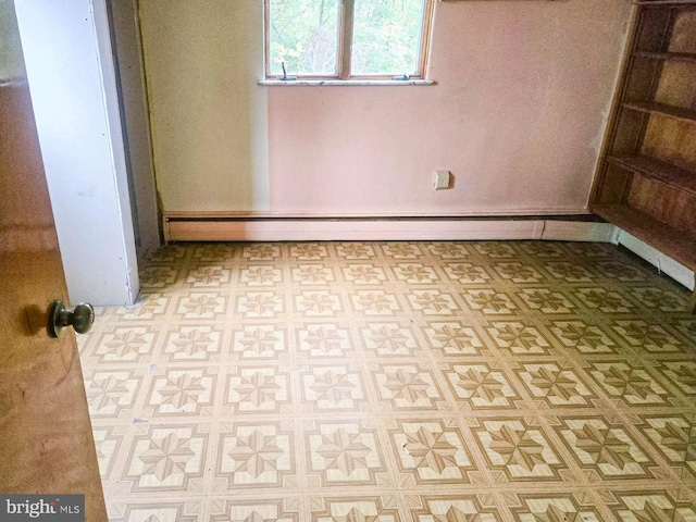 empty room featuring a baseboard radiator