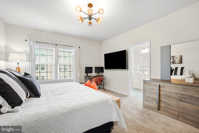 bedroom with a chandelier, ensuite bathroom, and light carpet