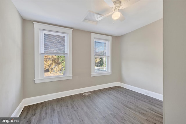 empty room with ceiling fan and hardwood / wood-style flooring