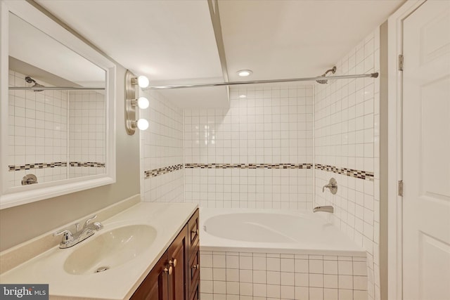 bathroom featuring vanity and tiled shower / bath