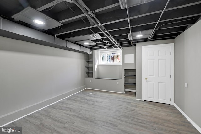 basement featuring wood-type flooring