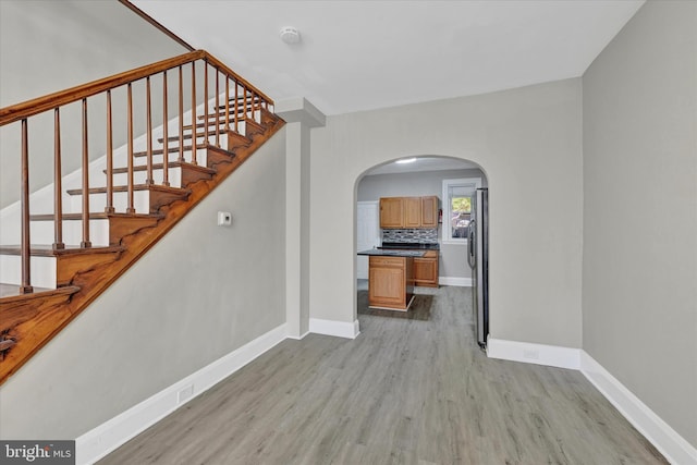 staircase with hardwood / wood-style floors