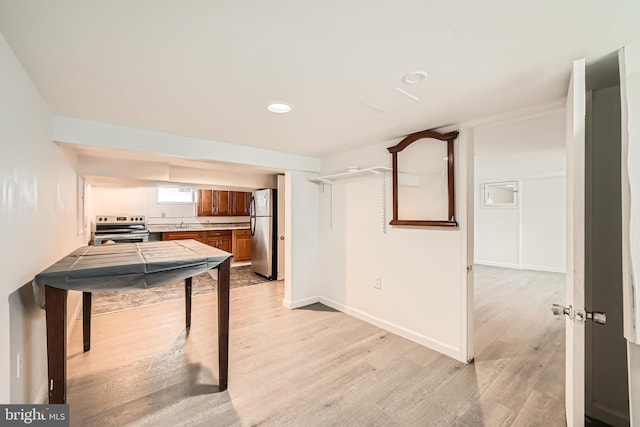 kitchen featuring light hardwood / wood-style floors and appliances with stainless steel finishes