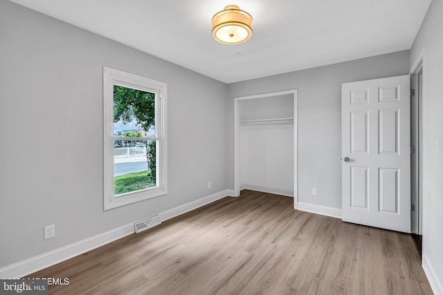 unfurnished bedroom featuring a closet and light hardwood / wood-style flooring