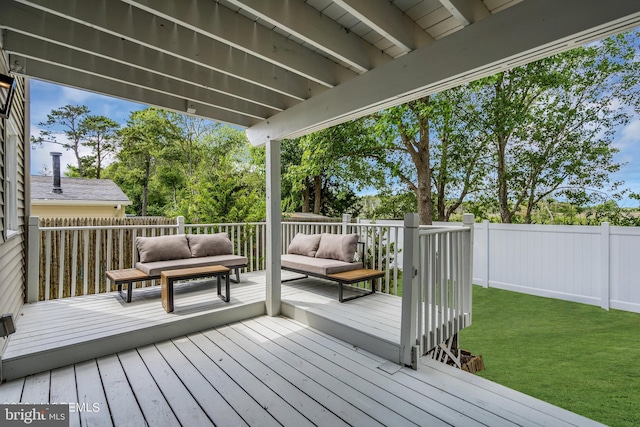 deck featuring outdoor lounge area and a yard