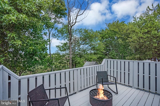 wooden deck with an outdoor fire pit