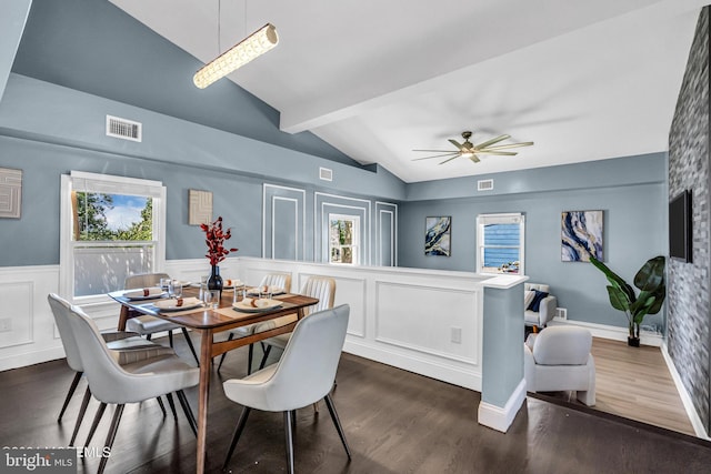 dining room with ceiling fan, dark wood-type flooring, and lofted ceiling with beams