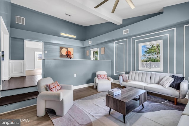 living room featuring lofted ceiling with beams, ceiling fan, and hardwood / wood-style flooring