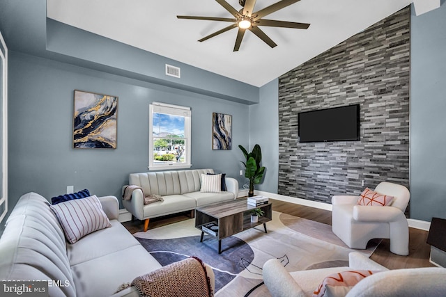 living room featuring light hardwood / wood-style flooring, high vaulted ceiling, and ceiling fan