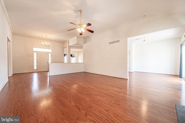 unfurnished living room featuring ornamental molding, ceiling fan with notable chandelier, visible vents, and wood finished floors