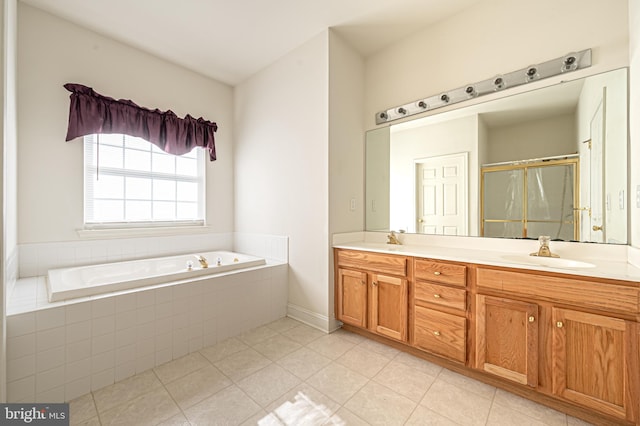 full bathroom featuring a garden tub, a sink, a shower stall, tile patterned floors, and double vanity