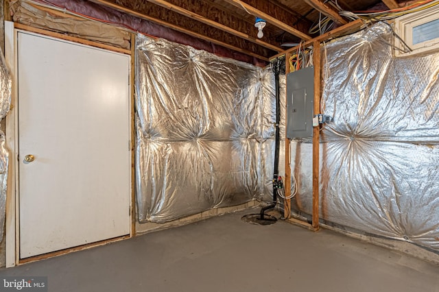 unfinished basement featuring electric panel