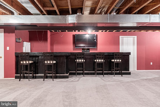 bar featuring a dry bar, carpet, and freestanding refrigerator