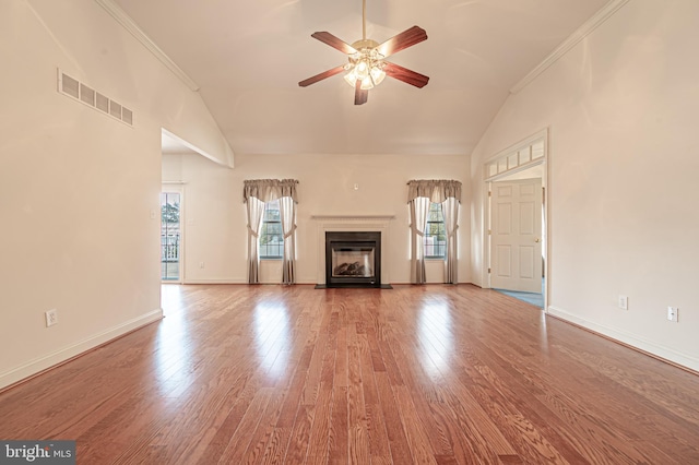 unfurnished living room featuring high vaulted ceiling, a fireplace with flush hearth, visible vents, and wood finished floors