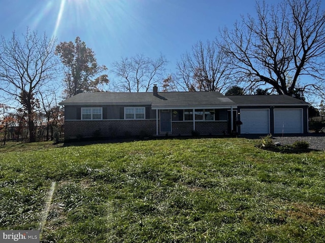 single story home with a front yard and a garage