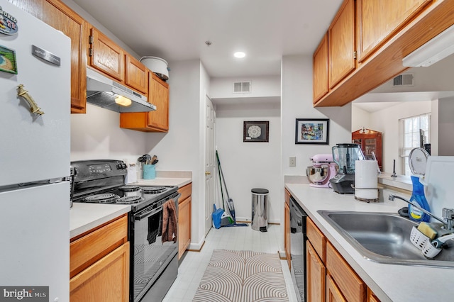 kitchen with sink, light tile patterned floors, and black appliances